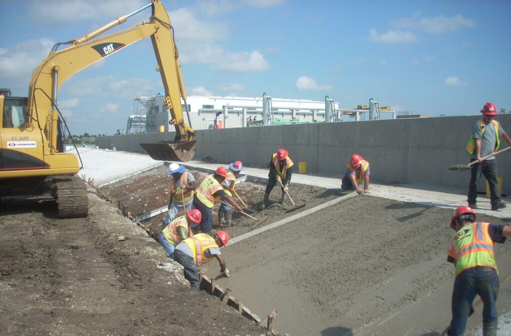 Cycle Construction's workers setting up slop paving for Whitney Barataria pumping station flood wall