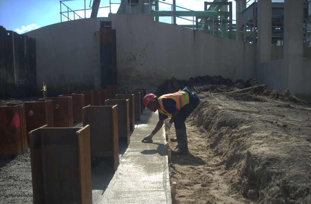 Cycle Construction's workers setting up stab slab for Whitney Barataria pumping station flood wall