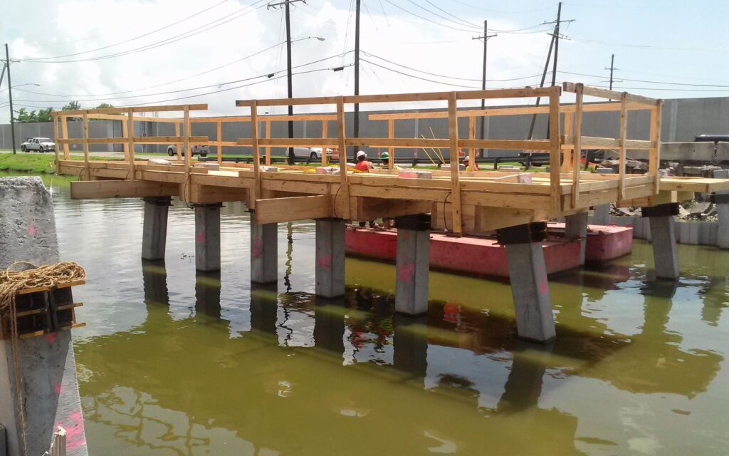 Cycle Construction's workers setting up pile bents for Gardere Canal Phase III and Murphy Canal Phase I